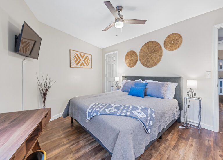 King Bedroom with SmartTV, desk, dresser, mirror, and spacious closet