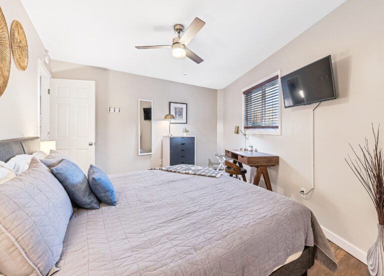 King Bedroom with SmartTV, desk, dresser, mirror, and spacious closet