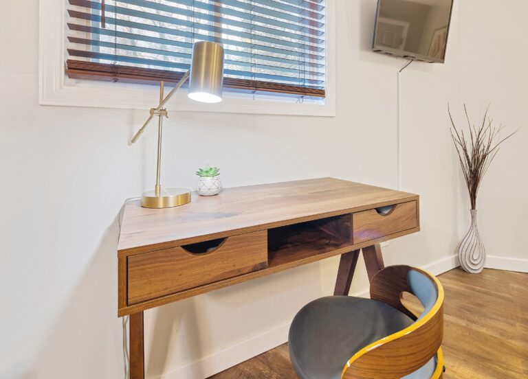 Nice comfortable workspace with desk, lamp, and chair