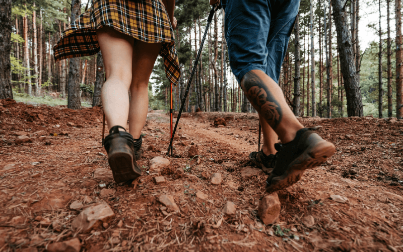 Couple hiking a colorful wooded trail near Maggie Valley