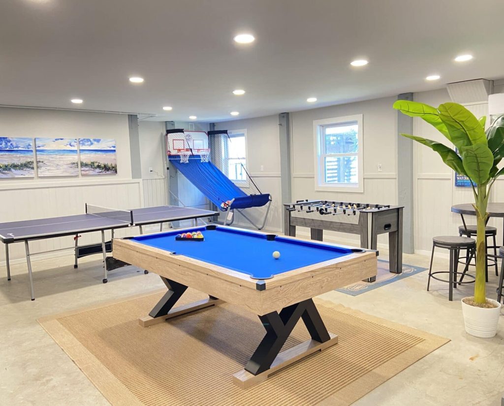 Large game room with new pool table, ping pong, foosball, and new basketball game
